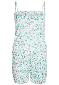 Jumpsuit floral avec bretelles fines, présentant un fond blanc et des motifs floraux verts, violets et gris. Taille élastique avec cordon de serrage.