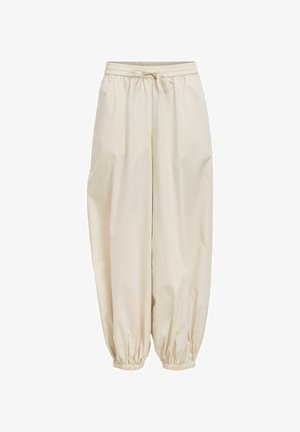 Bézs, laza szabású nadrág rugalmas derékpánttal és húzózsinórral, gumis mandzsettákkal a bokánál, lezser stílusban.