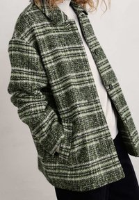 Grüne und weiße karierte Jacke aus strukturiertem Stoff, mit Kragen, Knopfverschluss und entspannter Passform. Bemerkenswert ist ihr oversized Design.