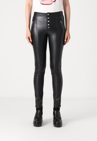 Black faux leather high-waisted pants featuring a five-button front closure, zippered pockets, and vertical stitching details.