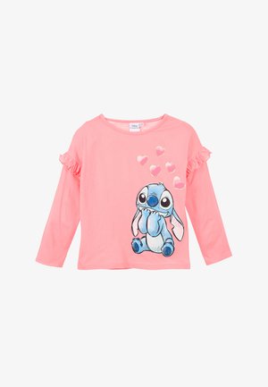Lange mouw roze shirt met ruches, featuring een blauwe cartoonfiguur en metallic harten als decoratie. Gemaakt van zachte stof.