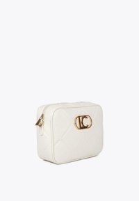 White quilted cosmetic bag with a gold zipper and logo. It features a sleek rectangular design, showcasing an elegant and modern style.