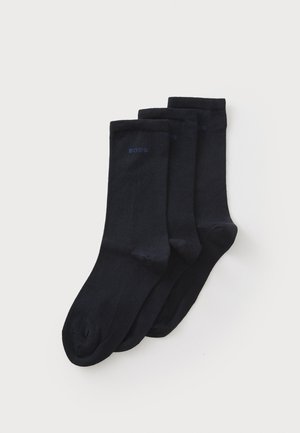Three pairs of black socks made from a smooth material, featuring a ribbed cuff and subtle branding in dark blue on the side.