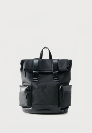 Black roll-top backpack with two front buckle straps and two zippered side pockets on a white background.