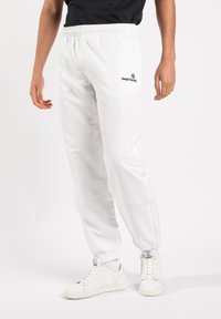 Witte joggerbroeken met een elastische taille, in een tapered fit, met een zwart logo op de linker bovenbeen en geribbelde boorden bij de enkels.