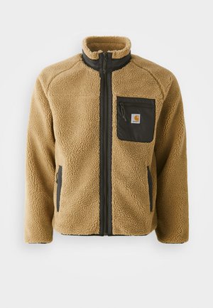 Tan fleece jacket with a black zippered chest pocket and matching side pockets. Features a high collar and textured fabric for warmth.