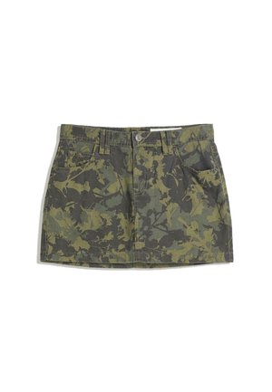Green camo denim skirt with a fitted waist, four pockets, and a button closure. Pattern includes dark and light green leaf designs.