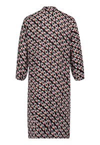 Väljettävän tunika, jossa on kuusikulmainen kuvio mustana, punaisena ja valkoisena. Lyhyet hihat ja pyöreä kaula-aukko. Sujuva rakenne.