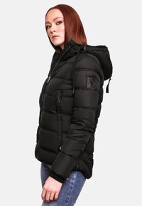 Black padded jacket with a hood, featuring a zip front, elastic cuffs, and a logo patch on the sleeve. Smooth texture and quilted design.