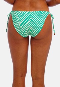 Bas de maillot de bain vert avec un motif en chevron blanc, doté de liens latéraux réglables et d'une finition lisse et texturée.