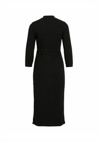 Black, long-sleeved dress made of soft fabric. Features a high neckline and a belted waist, with a straight cut to the ankle. Side slits present.