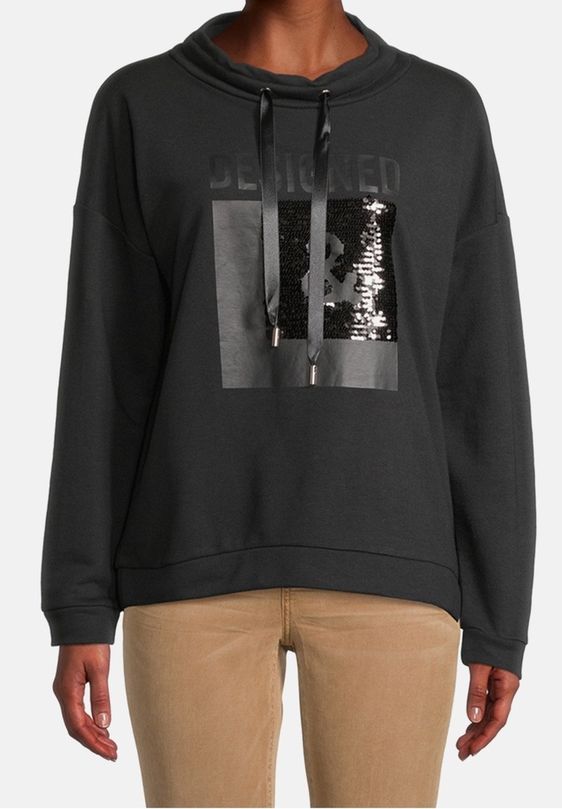 Sweatshirt noir avec un col cheminée, doté d'un patch graphique en sequins et de cordons de serrage. Tissu doux, coupe décontractée et poignets côtelés.
