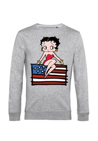 Sudadera gris con un personaje de dibujos animados sentado sobre una bandera estadounidense, con colores vibrantes en rojo, blanco y azul, y acentos en negro.