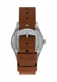 Timex ur med et sølvur og rem af brunt læder. Remmen har syninger og flere justeringshuller.