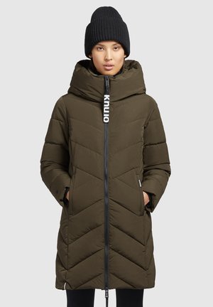 Olijfgroen pufferjas met een ritssluiting, chevronpatroon en grote capuchon. Heeft een logo aan de voorkant en zijzakken. Inclusief zwarte gebreide beanie.