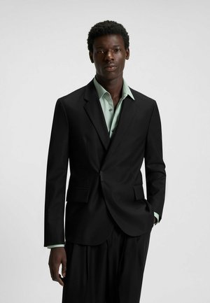 Black tailored blazer with notch lapels, paired with a mint green shirt. The fabric has a smooth texture and structured fit.