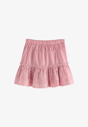 Lyserød bomulds-skjørt med flæset kant, broderede udskæringsmønstre og elastisk talje for komfort. Bølgeformede kanter præger kanten.