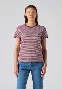 Maroon and white striped t-shirt with short sleeves, round neckline, and small logo on the chest, paired with blue denim jeans.