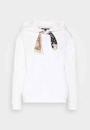 Weißes Kapuzen-Sweatshirt mit langen Ärmeln, verziert mit einem beigen und schwarzen Seidenschal, der am Hals gebunden ist.