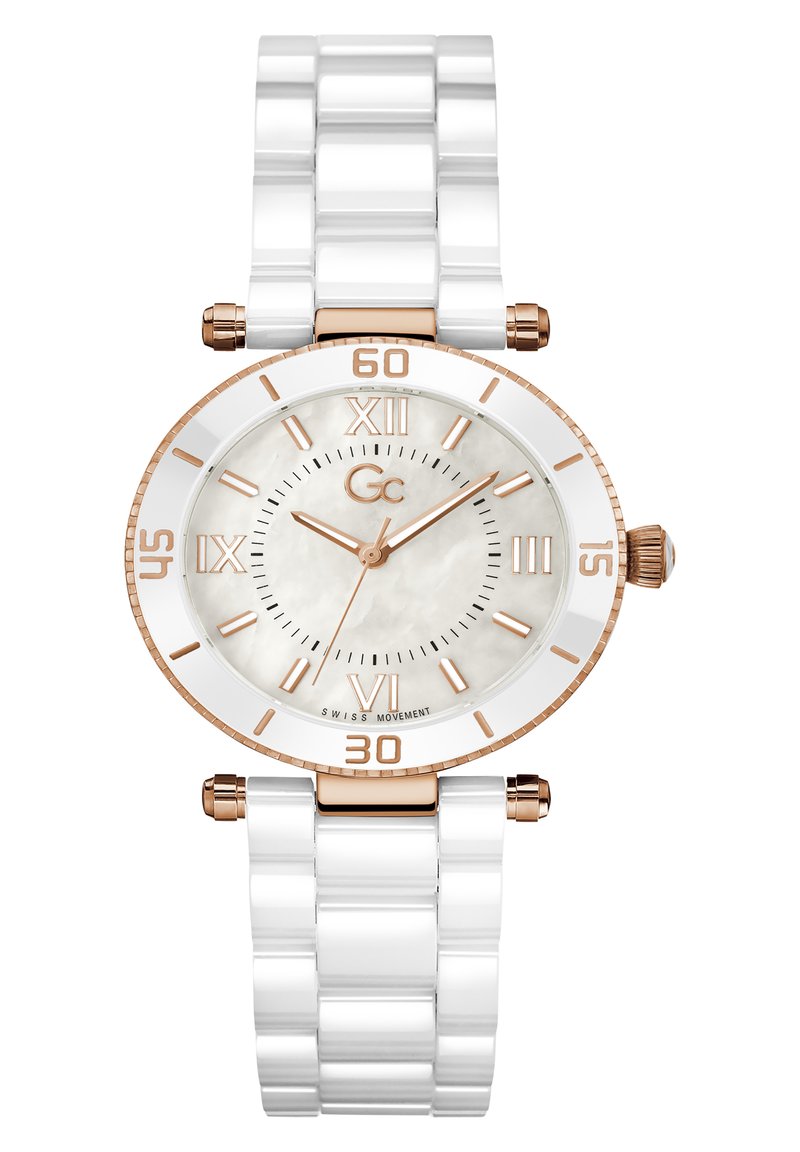 Valge keraamiline kell ümmarguse roosakuldse raami, valge kellakuju ja roosakuldse rooma numbriga. Omaduseks on tekstureeritud valge link-käevõru.