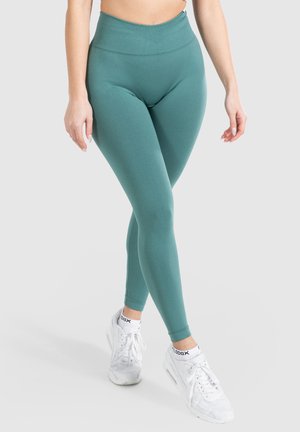 Hoogwerkende teal leggings van een gladde, rekbare stof, voorzien van een geribde tailleband en een taps toelopend enkeldesign.