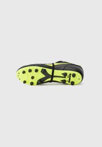 Black and neon yellow soccer cleat with black studs, shown from the sole, featuring Diadora branding on a white background.