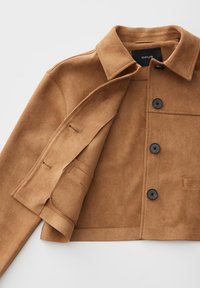 Brown cropped jacket with black buttons, spread collar, and visible inner suede lining, laid flat on a light background.