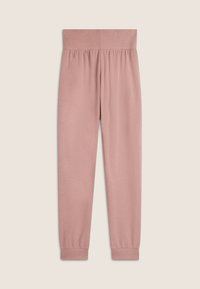 Pantalons de survêtement rose doux avec une large taille élastique, des poignets froncés et une texture lisse. Design simple sans motifs ni accents.