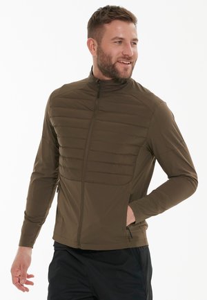Grüne, leichte Jacke mit Reißverschluss, gesteppte Vorderpaneele und Seitentaschen. Hergestellt aus glattem, dehnbarem Material im schlanken Schnitt.