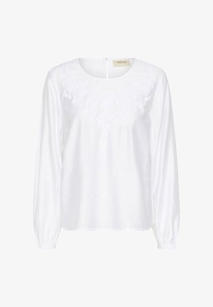 Bijela bluzica s dugim rukavima i okruglim izrezom, s cvjetnim vezom na prsima i elastičnim manžetama za opušteni stil.