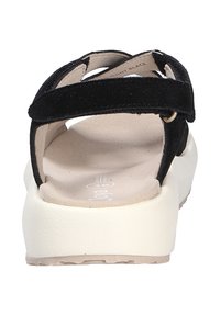 Sandali neri in suede caratterizzati da due cinturini regolabili, una suola in piattaforma di colore crema e una soletta imbottita con finitura texturizzata.