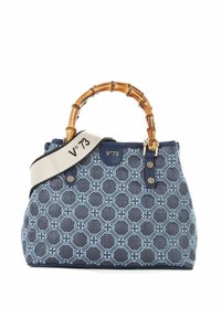 Sac à main à motif navy avec des poignées en bambou, équipé d'une bandoulière blanche arborant un logo noir. Matériau texturé et accents en métal doré.