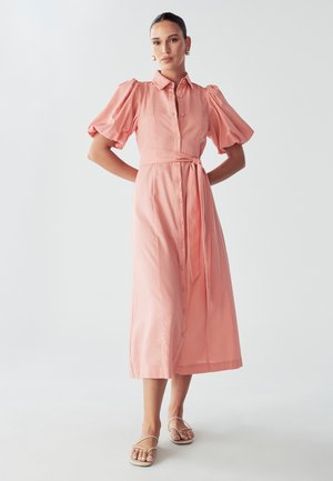 Pink button-up dress with puffed short sleeves, belted waist, and a mid-length cut. Smooth fabric with a lightweight texture.