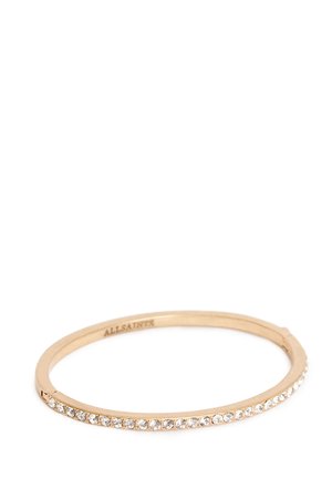 Dunne gouden bangle armband met een rij heldere kristallen langs één kant en "ALLSAINTS" gegraveerd aan de binnenkant.
