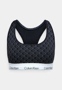 Sort sportstop med mønstret tekstur, racerback-design og et kontrastfarvet hvidt bånd med "Calvin Klein"-logo.