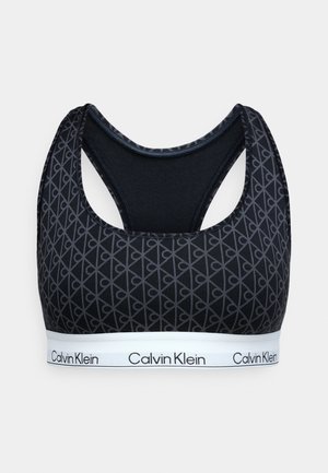 Schwarzer Sport-BH mit gemustertem Textil, Racerback-Design und einem kontrastierenden weißen Band mit "Calvin Klein"-Logo.