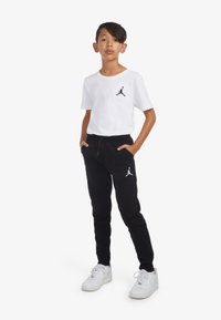 Jordan ESSENTIALS PANT UNISEX - Pantalones deportivos - black