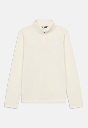 Pull à col montant beige en polaire avec fermeture éclair quarter-zip, logo The North Face gris clair sur la poitrine gauche. Texture douce.