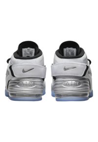 White and silver athletic shoes with a chunky design, featuring a black interior, adjustable strap, and clear sole with blue accents.