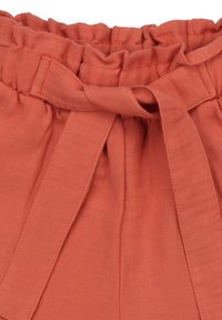 Rust-colored waistband with gathered elastic and a fabric tie. Smooth texture with sewing details at the edges. Designed for a relaxed fit.