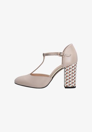 Beige T-strap high heel with a smooth leather upper, geometric patterned block heel in white, red, and black, featuring a metallic buckle.