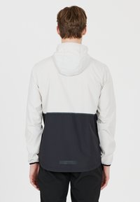 Endurance HUGOEE - Juoksutakki - lichtbeige