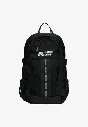 Zwarte Superdry rugzak met meerdere ritssluitingen, reflecterende verticale strip en bovenhandvat.