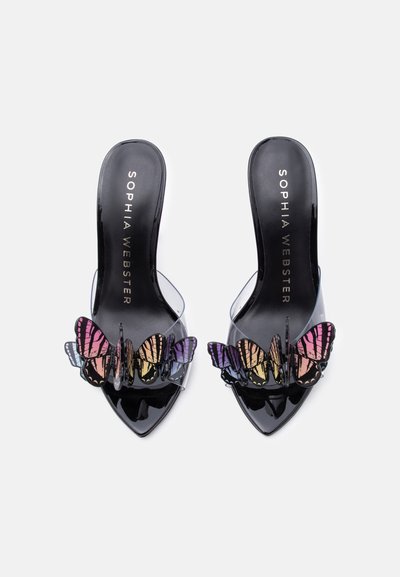 Μαύρα πέδιλα με τακούνι και μυτερή μύτη, με διάφανα λουράκια και πολύχρωμες πεταλούδες διακοσμημένες μπροστά.