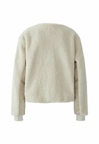 Vanzelfsprekend beige jasje met een gestructureerde buitenkant, voorzien van zachte stof en gladde beige mouwen. Ribboorden aan de onderkant en de uiteinden van de mouwen.