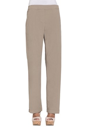 Pantaloni beige a gamba dritta indossati con una maglia bianca e sandali con zeppa di sughero rosa chiaro, mostrati dalla vita ai piedi.