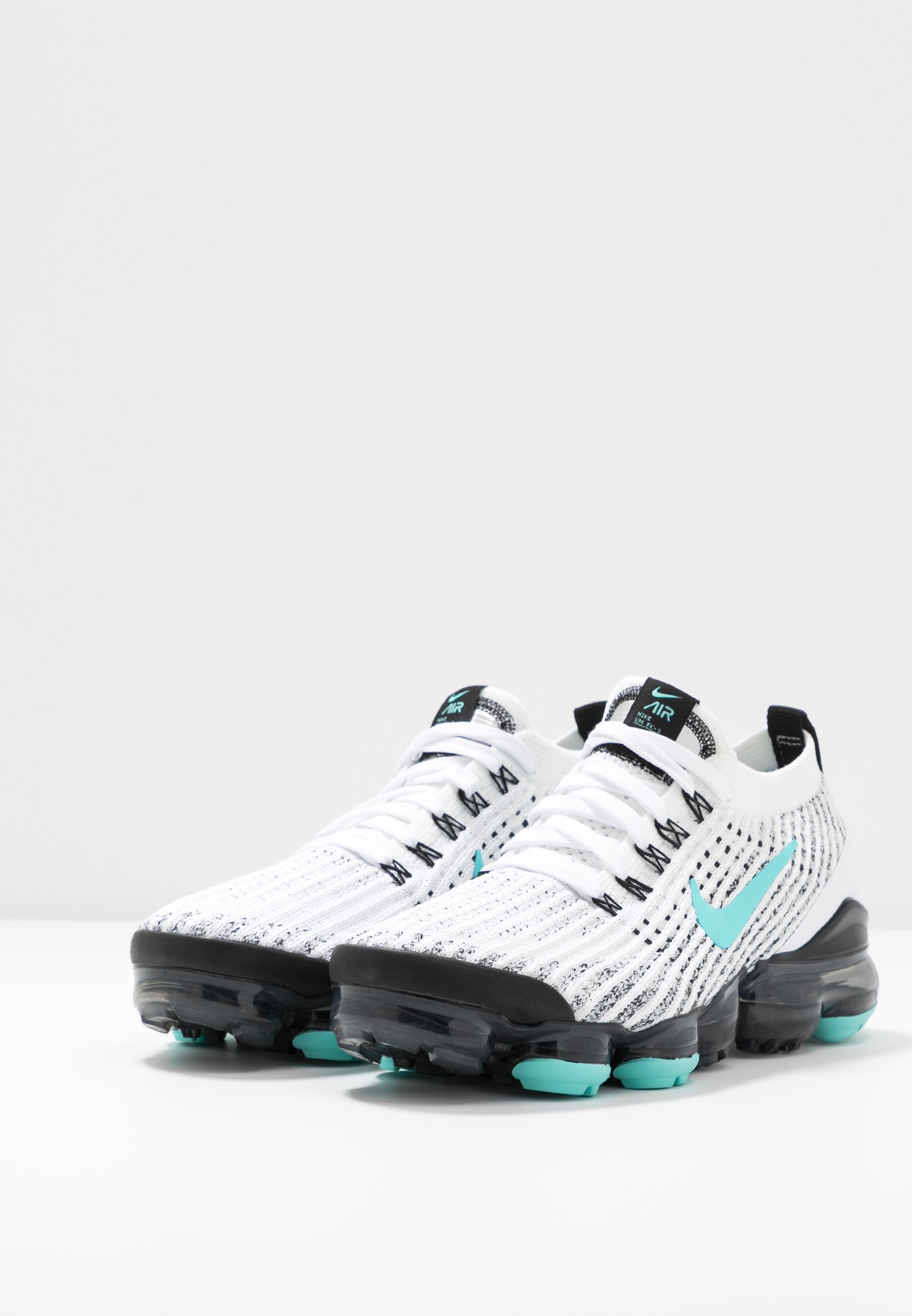 green and black nike trainers