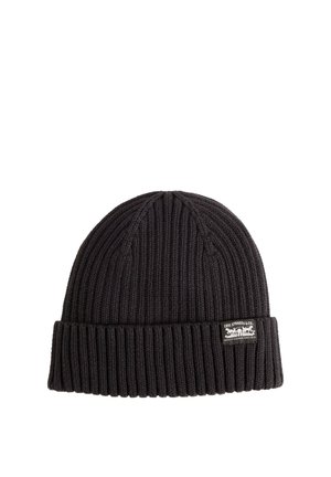 Black ribbed knit beanie with folded cuff featuring a small Levi Strauss & Co. logo patch on the front side.