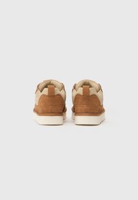 Brown suede and beige mesh shoes with a padded collar, white rubber sole, and rectangular pull tab at the back.