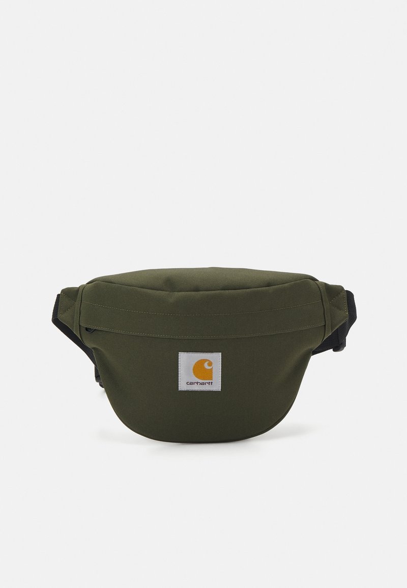 Sacoche taille olive en tissu durable, de forme arrondie, avec un haut zippé, une sangle noire et une étiquette logo jaune à l'avant.